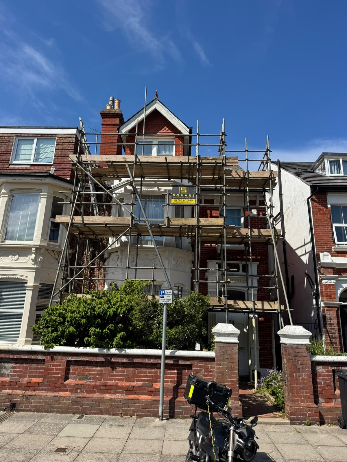 Scaffolding erected quickly to the front of a three-storey terraced property from the pavement