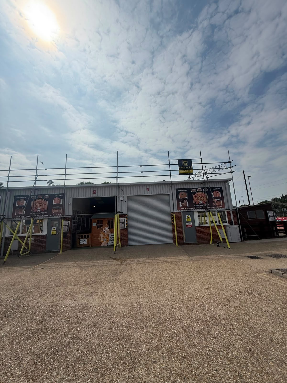 Scaffolding across the front of an industrial unit with roller shutter access kept clear