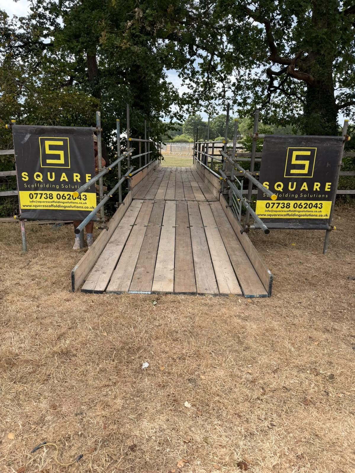 Boarded scaffold access walkway with double guardrails and toe boards