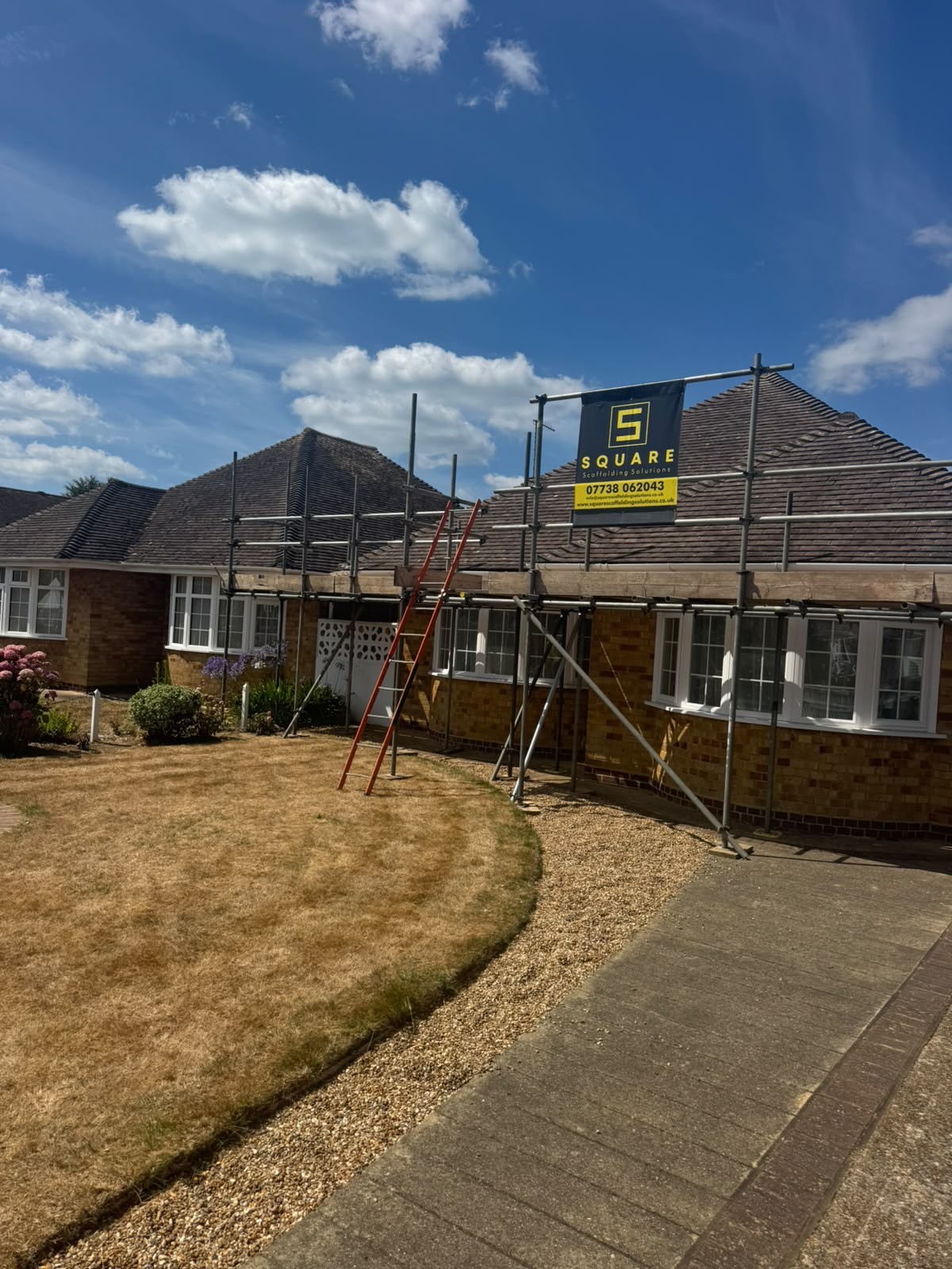 Chimney and roof access scaffolding on a brick bungalow