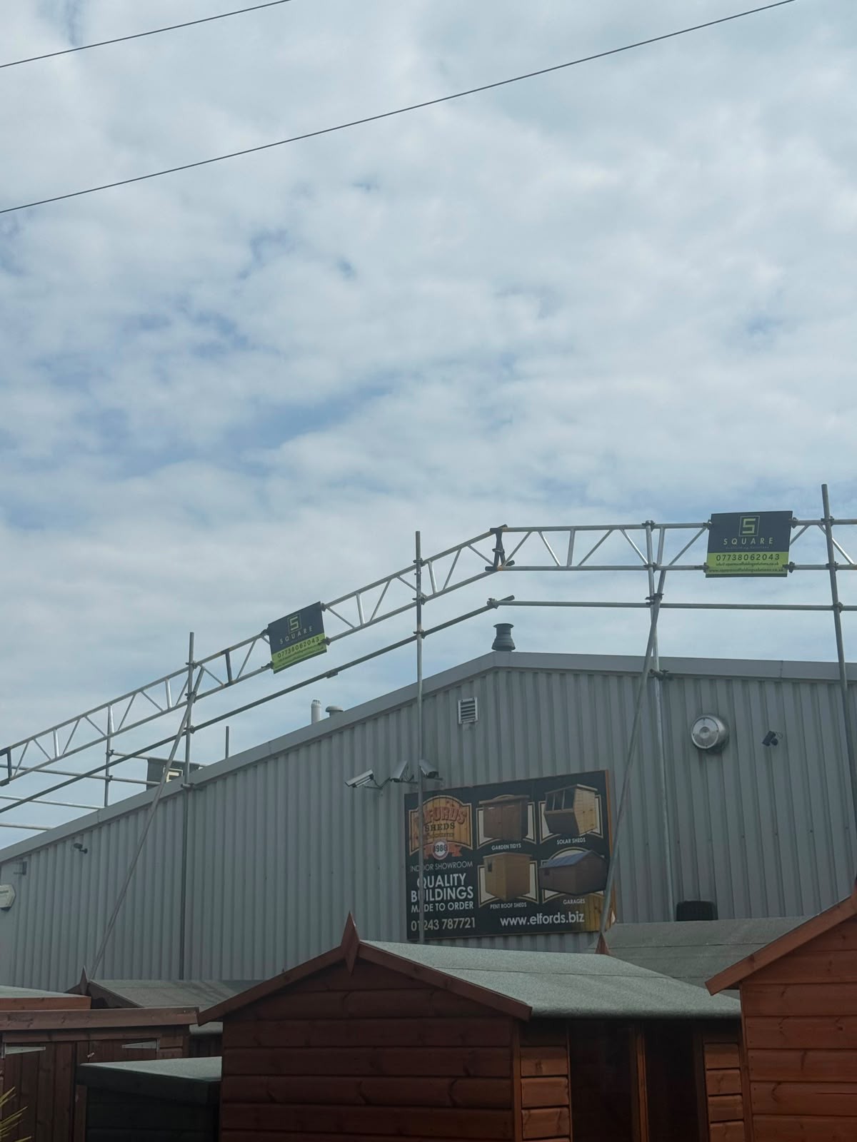 Commercial scaffolding erected above an industrial unit roof in West Sussex